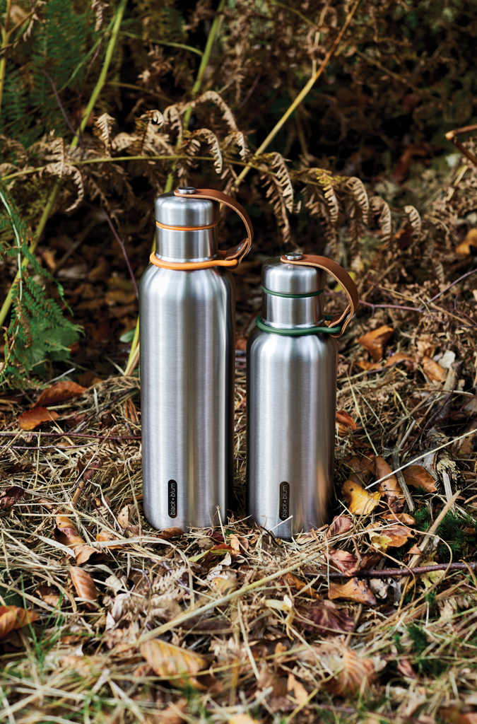 Deux gourdes inox posées sur l’herbe sèche