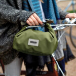 Sac repas vert accroché à un vélo.