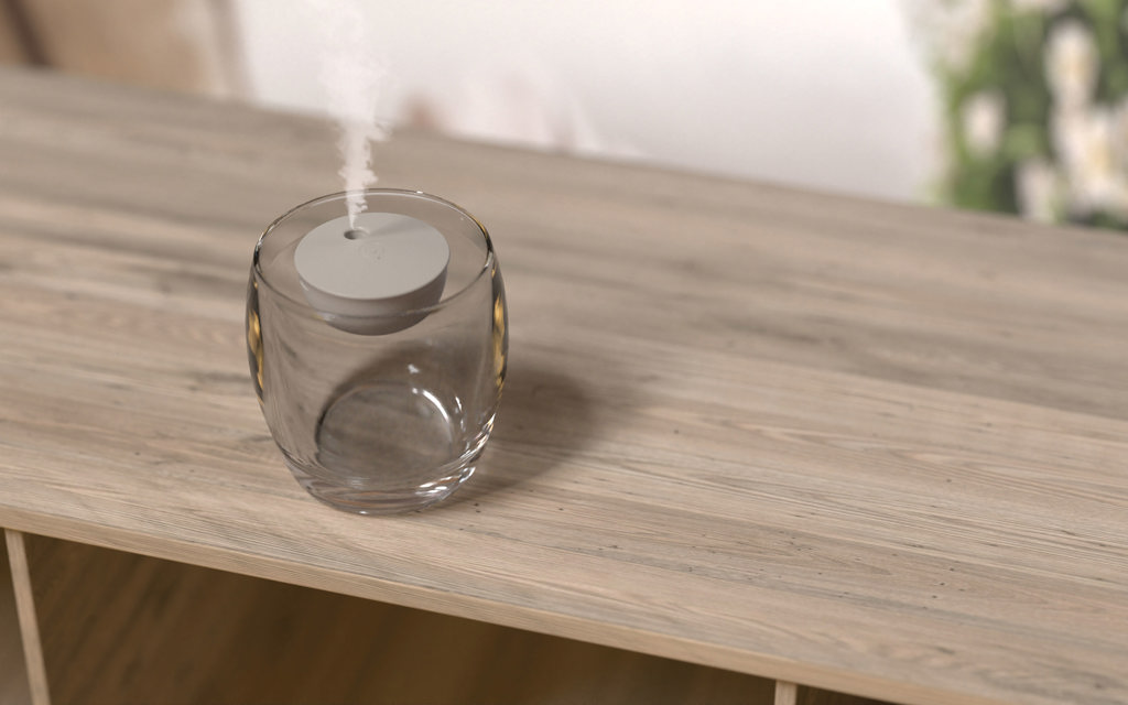 Diffuseur d'arômes en verre sur table en bois