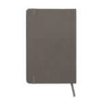Carnet gris fermé avec élastique et ruban.