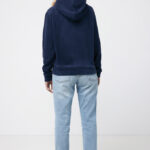 Personne portant un hoodie bleu et un jean clair.