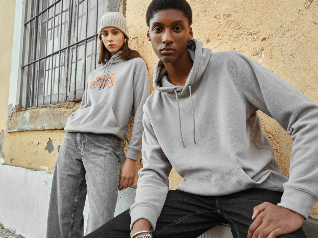 Deux personnes portent des sweats gris décontractés.