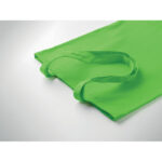 Sac cabas vert en tissu sur surface blanche