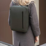 Personne portant un sac à dos vert élégant