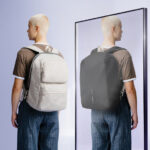 Personne portant un sac à dos devant un miroir