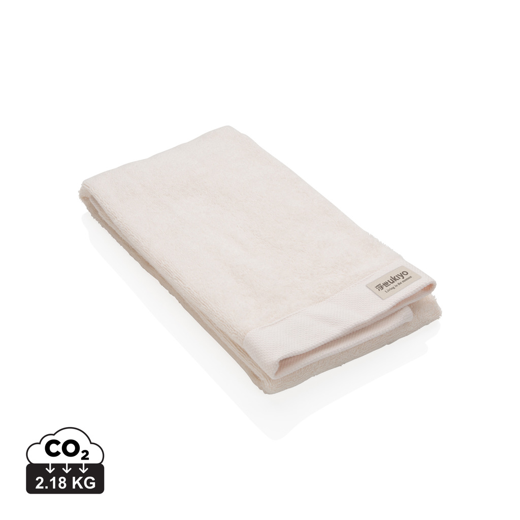 Serviette beige pliée avec étiquette Ukiyo