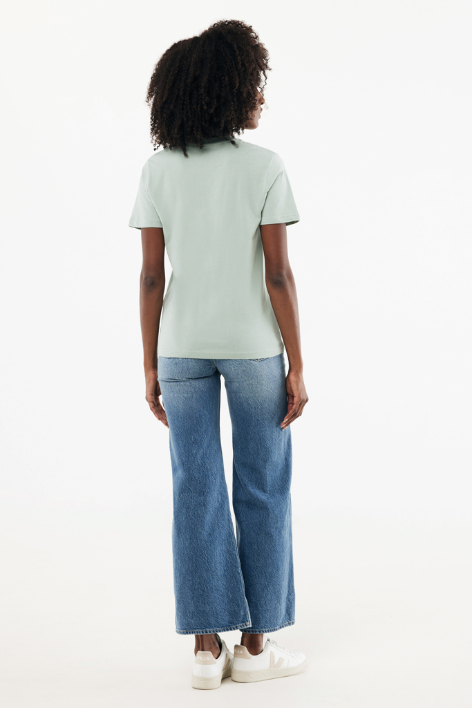 Femme de dos en t-shirt vert clair