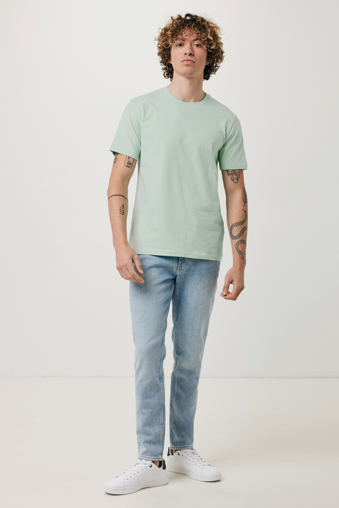 Homme en t-shirt vert et jean clair