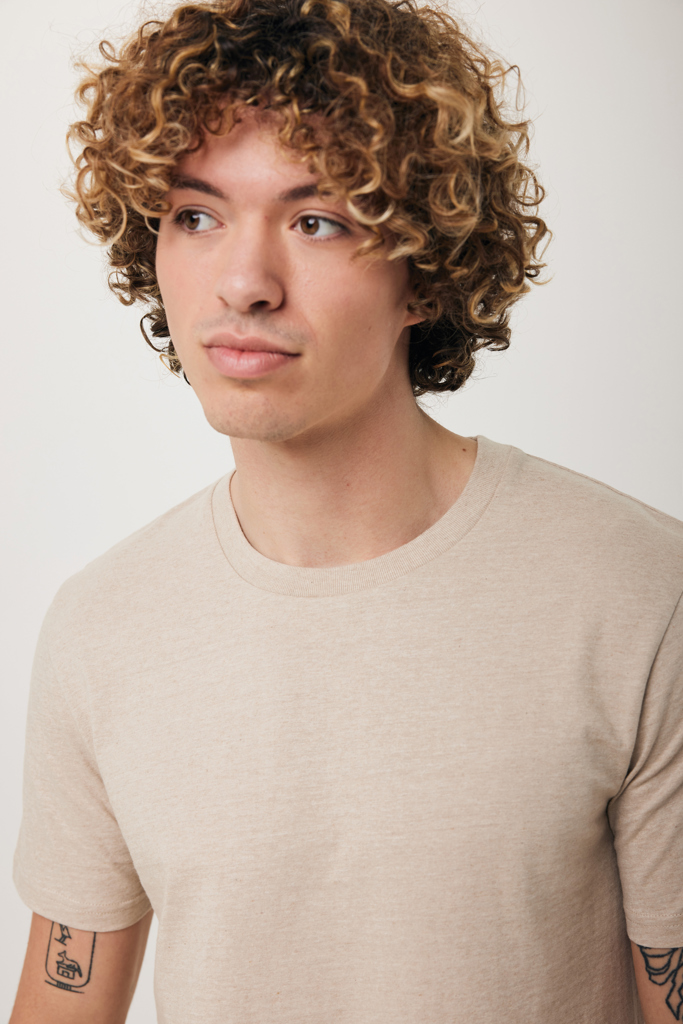 Jeune homme aux cheveux bouclés en t-shirt beige