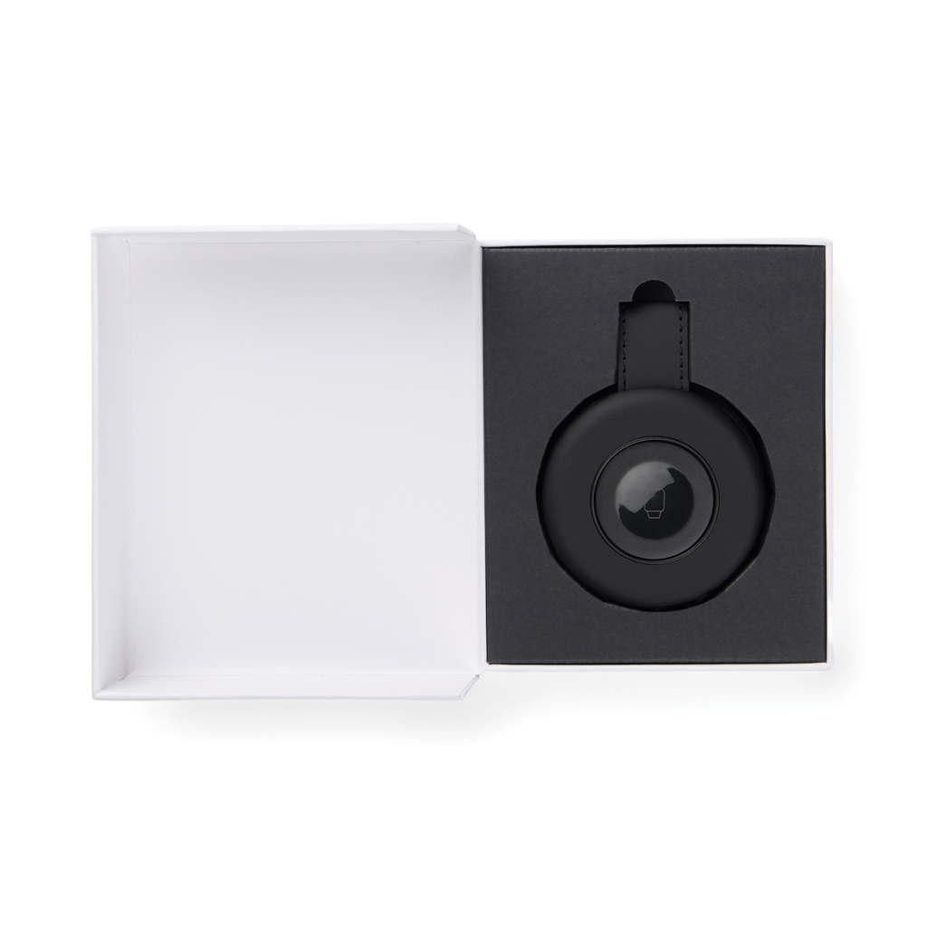 Boîte ouverte avec appareil circulaire noir