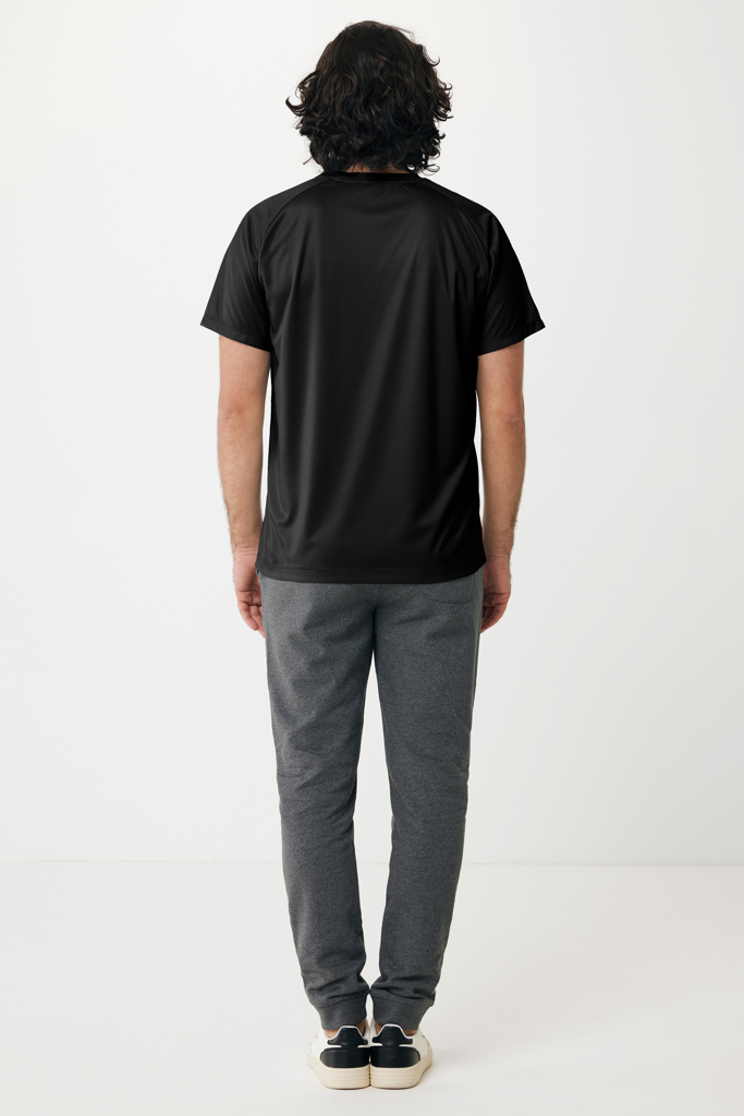 Homme de dos en t-shirt noir et jogging gris