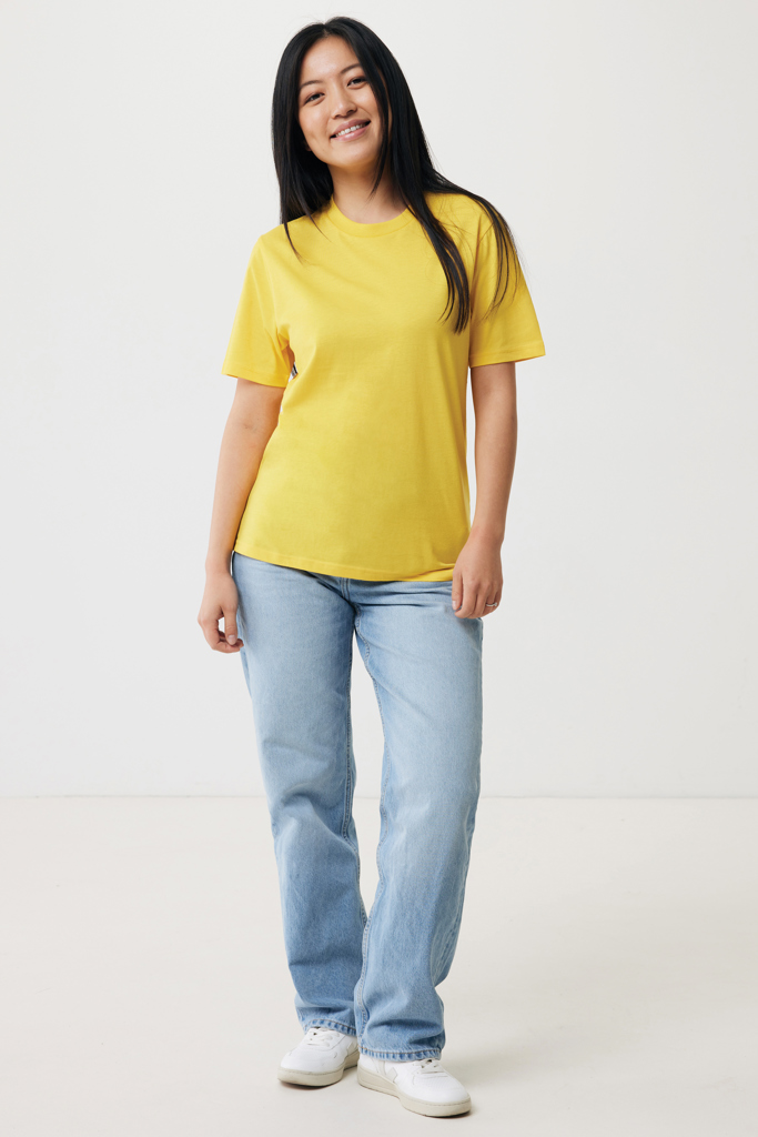 Femme souriante en t-shirt jaune et jean