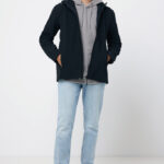 Homme portant veste noire, hoodie gris, jean clair