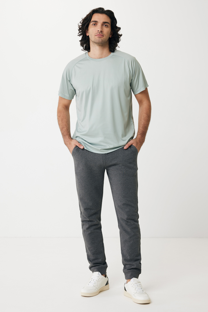 Homme en t-shirt vert et pantalon gris