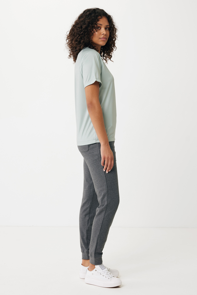Femme en t-shirt vert et jogging gris